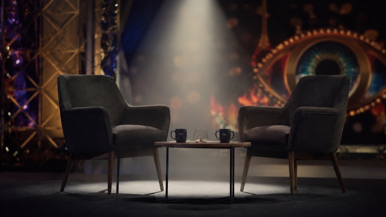 AI illustration of a spotlight on a stage with a microphone, symbolising celebrity personal disclosure on reality TV