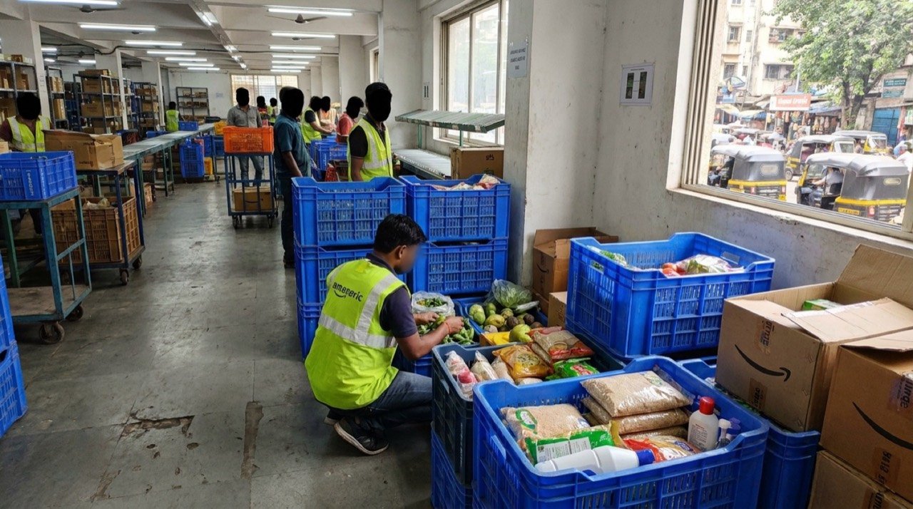 Amazon delivery worker handling everyday grocery essentials at an urban fulfilment centre in India