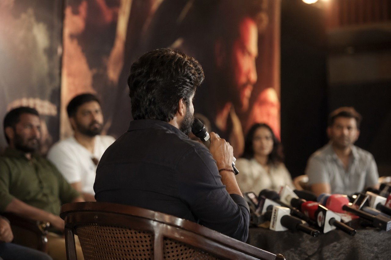 A dimly lit film set with a director's chair and script pages, evoking the making of a Telugu psychological drama