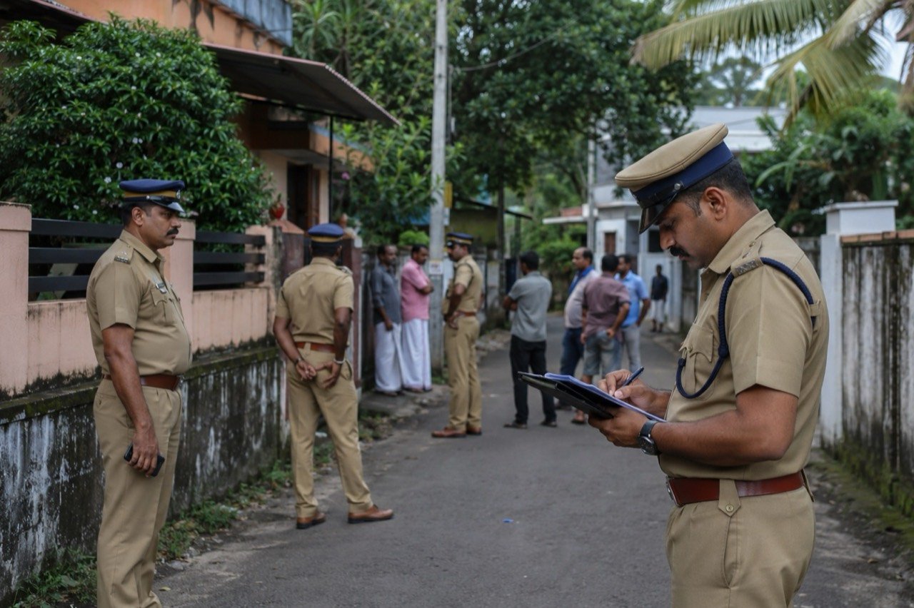 Police personnel outside a rented house in Thrissur, Kerala, being investigated in connection with a fatal assault and an alleged prostitution racket.